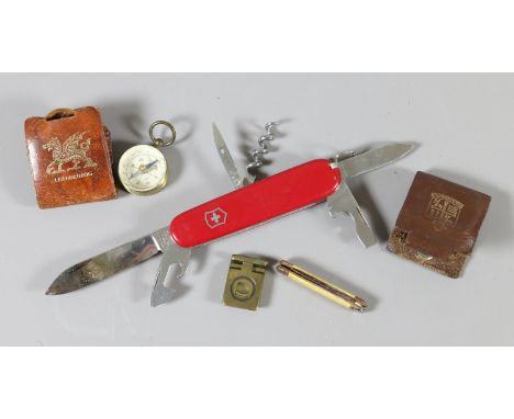 A box of collectables to include a Swiss Army knife and a pocket compass.