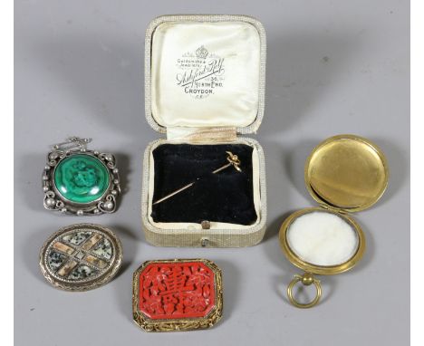 An cinnabar lacquer style filled brooch along with a Malachite brooch, brass locket, yellow metal stick pin and a similar whi