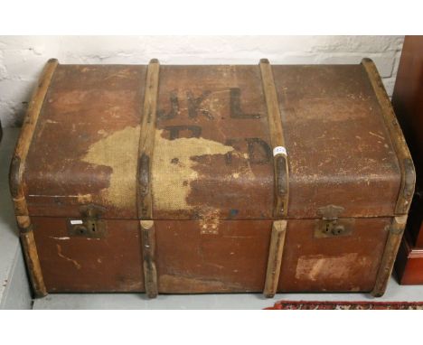 A wooden bound travel trunk and two vintage suitcases.