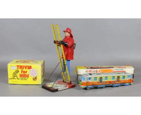A Mar toys clockwork tinplate model climbing fireman, a Japanese boxed tinplate model of an internal combustion train and a b