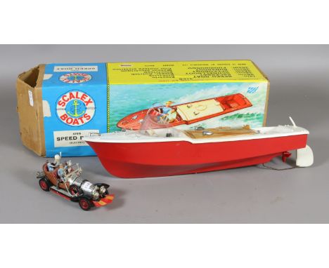 A boxed scale model of a battery powered speed boat and a Corgi Chitty Chitty Bang Bang with all four original passengers and