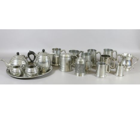 A collection of various pewter tankards to include Sheffield made examples along with a four part pewter tea service and tray