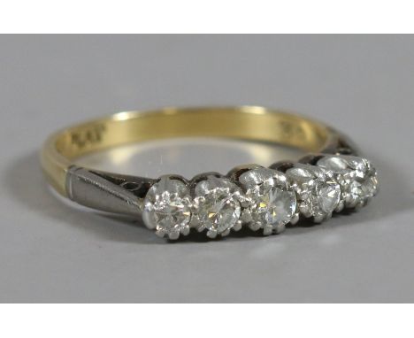 A ladies 18ct gold and platinum five stone diamond ring, size M.