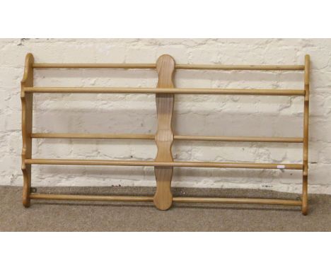 An Ercol Golden Dawn wall mounted plate rack.