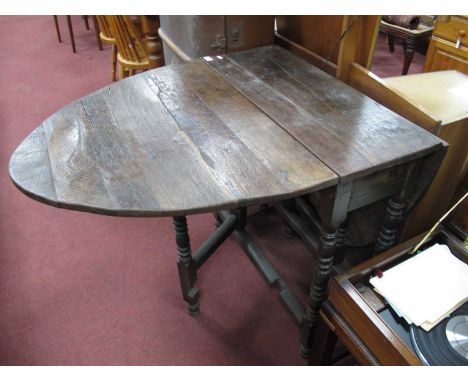 XVIII Century Oak Gate-Leg Table, with drop leaves, on turned legs.