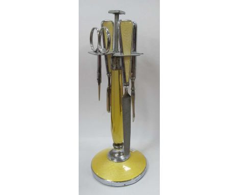 A 1970s chrome and enamel effect nail vanity set with an amber faceted glass centre.