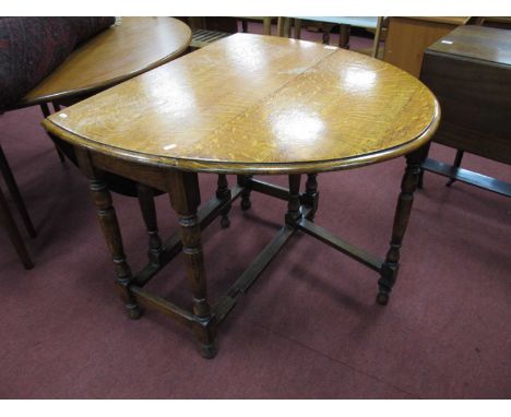 1930s Oak Gate Leg Table, with drop leaves on turned and block supports, united by stretchers.