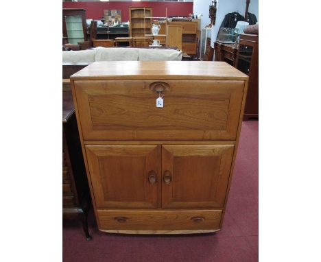 Ercol Cabinet, with a fall front over twin cupboard doors, long drawer, on castors, 82cm wide x 110cm high.