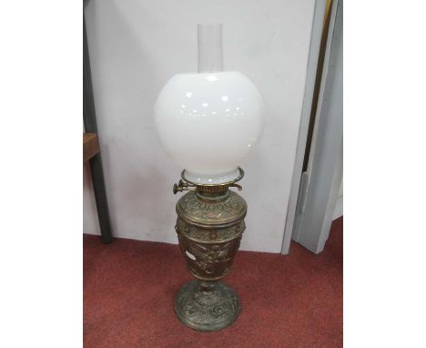 XIX Century Bronzed Cast Iron Oil Lamp, with a glass shade and funnel, decorated with winged cherubs, base with a C scroll de
