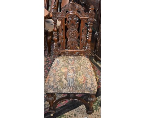 A William III style oak side chair, the arched back pierced and profusely carved with scrolling acanthus, turned supports, st
