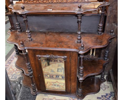 A Victorian walnut whatnot, the shaped superstructure comprising an arrangement of open shelves supported by spirally fluted 