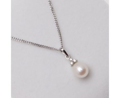 mounted with a cultured pearl measuring approximately 7.00mm suspended from a 9ct white surmount set with three circular-cut 