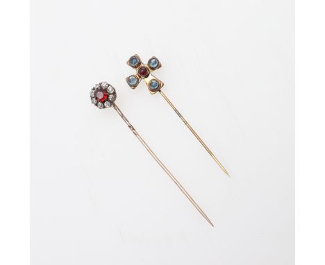 the circular-cut garnet is set within a surround of old-cut diamonds, in gold, together with a gold and gem set stick pin in 