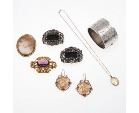 including a wide silver half hinged bangle, with foliate decoration to one side, a pair of cut steel buckles, a pair of cameo