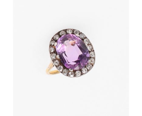 the oval-shaped amethyst is set within a surround of old-cut diamonds, in silver and gold, 4.9 grams. Size L. *CR Some wear, 