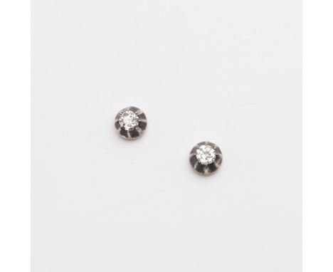 each earring set with a circular-cut diamond in silver and gold, the posts split to secure, 1.3 grams. *CR Some wear to the m