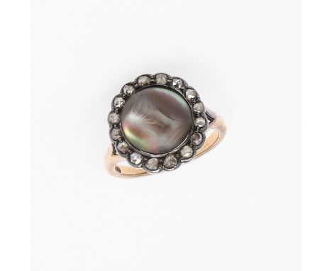 the circular abalone pearl is set within a surround of rose-cut diamonds, in silver and gold, 4.5 grams. *CR with some wear.