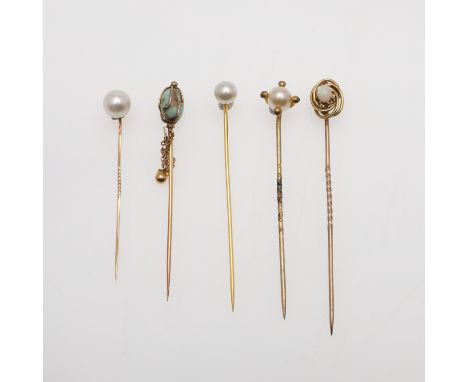 mounted with an oval-shaped solid white opal, in gold, together with a turquoise set stick pin and three other stick pins, to