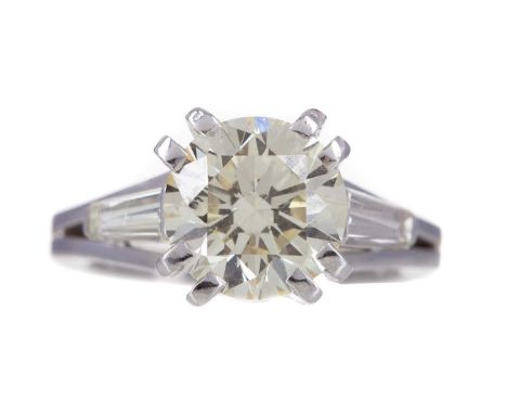 IMPRESSIVE DIAMOND SOLITAIRE RING,the round brilliant cut diamond of approximately 3.01 carats, flanked by tapered baguette c