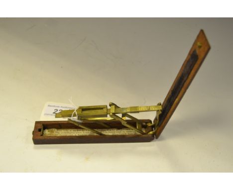 A George III brass folding guinea scale, mahogany case,  with applied plush velvet strip to the underside of the lid, instruc