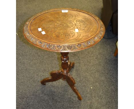 A mid 20th Century carved mahogany lamp table, carved tripod base.