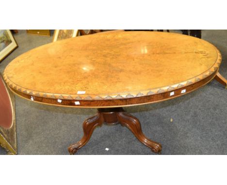 A Victorian  burr walnut and marquetry breakfast table, quarter veneered top inlaid with scrolling leafy stems, carved border