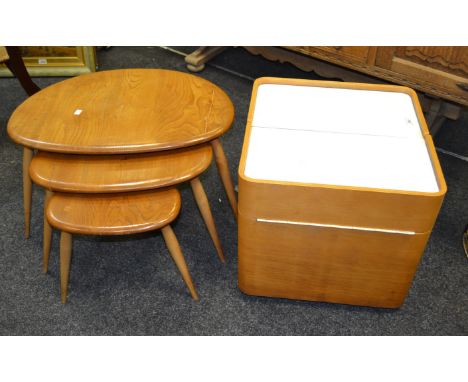 A nest of Ercol coffee tables, trio tapering legs; a 1960's cube design storage unit on teak casters