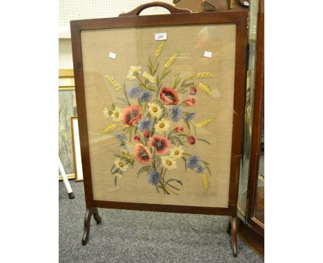 A mahogany firescreen, needlework panel depicting poppies and cornflowers.