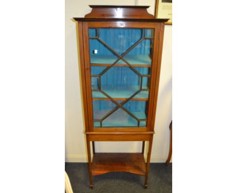 An Edwardian mahogany and satinwood crossbanded display cabinet, astragal glazed door, above incurved shelf c.1910