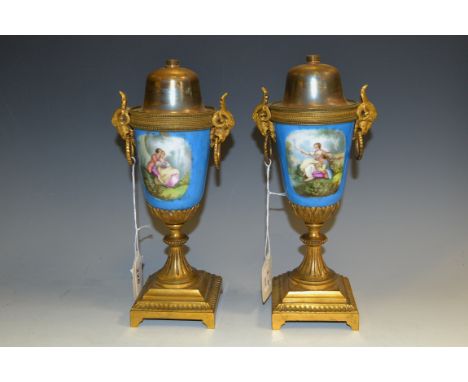 A pair of 19th century French porcelain and gilt metal urnular table lamp bases, decorated in the manner of Sevres with court