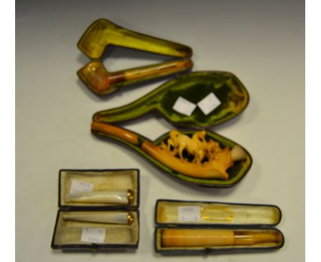 A late 19th century Meerschaum pipe. carved with a horse and rider, cased; two gold mounted 'mother-of-pearl' cheroot holders
