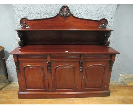 A VICTORIAN STYLE MAHOGANY SIDE CABINET the super structure with moulded shelf and carved cresting the base with three frieze