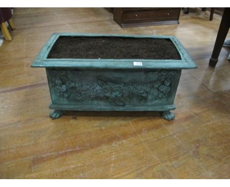 A BRONZE PLANTER of rectangular form the shaped moulded top above a foliate and flowerhead frieze on claw feet 40cm x 77cm
