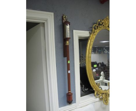 A GOOD WALNUT AND BRASS MOUNTED BAROMETER AND THERMOMETER of cylindrical form 93cm (h)