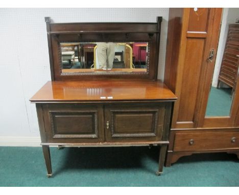 AN EDWARDIAN MAHOGANY SIDE CABINET the super structure with bevelled glass mirror and moulded shelf the base with cupboards o