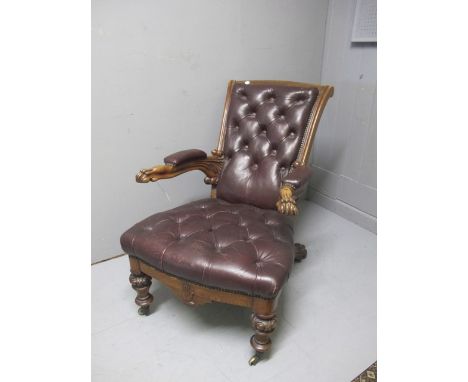 AN UNUSUAL VICTORIAN OAK LIBRARY CHAIR with deep button hide upholstered back and seat with carved claw arms raised on carved