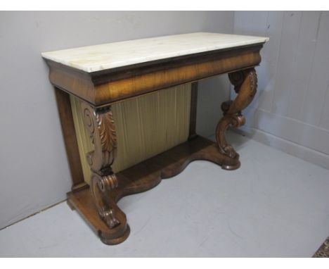 A VERY FINE REGENCY MAHOGANY CONSOLE TABLE surmounted with a vein marble top above a cavetto frieze raised on front scroll su