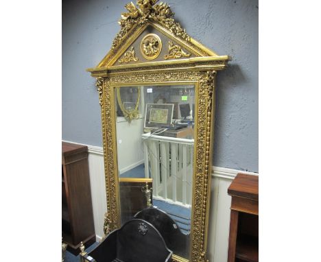 A FINE CONTINENTAL GILTWOOD AND GESSO MIRROR the architectural pedament with flowerheads, foliage and ho ho birds above a pan
