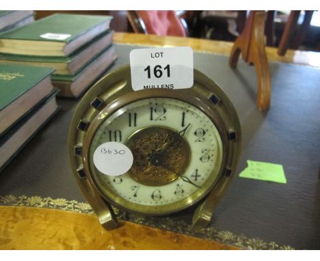 A BRASS MANTLE CLOCK in the form of a horse shoe together with a pair of brass fire pokers
