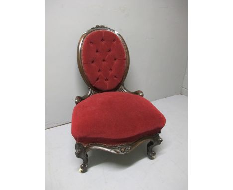 A VICTORIAN MAHOGANY LADIES CHAIR the oval back with foliate flowerhead cresting above a deep button upholstered back and sea