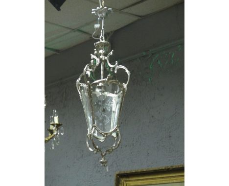 A CONTINENTAL SILVERED AND ENGRAVED GLASS SINGLE LIGHT HALL LANTERN with scroll arms and bowed panels with scroll terminals