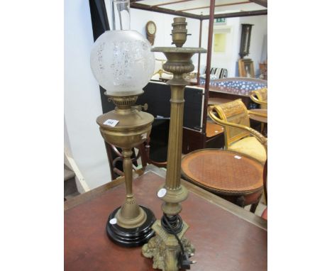 A BRASS TABLE LAMP with fluted column raised on scroll supports together with a brass oil lamp with etched glass shade