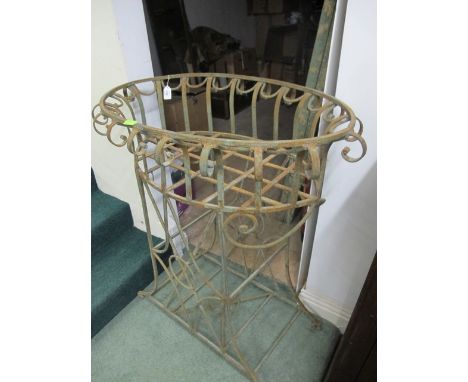 A WROUGHT IRON PLANTER of oval outline the shaped moulded top with scroll mounts raised on moulded outswept legs with scroll 
