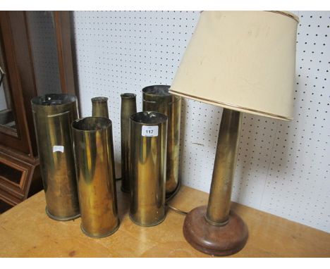 SIX BRASS SHELLS together with a brass table lamp