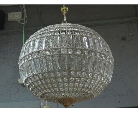 A CONTINENTAL GILT BRASS AND CUT GLASS CENTRE LIGHT of bulbous form decorated with faceted pendant and lozenge drops