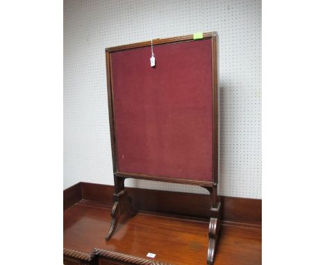A REGENCY MAHOGANY FIRESCREEN the rectangular upholstered screen with adjustable panels on standard end supports with scroll 