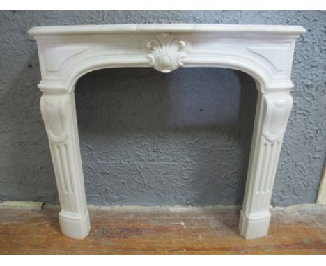 A FRENCH WHITE MARBLE CHIMNEY PIECE the serpentine moulded shelf above a shell carved frieze on fluted jabs 108cm (h) x 117cm