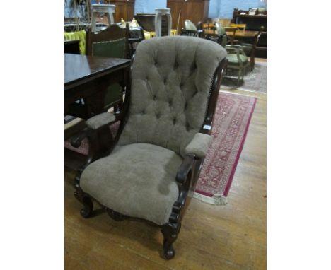 A VICTORIAN MAHOGANY AND UPHOLSTERED ELBOW CHAIR with deep button upholstered back and seat with scroll arms on cabriole legs