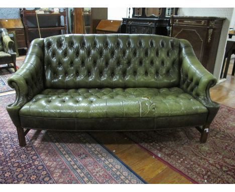 A GREEN HIDE UPHOLSTERED LIBRARY COUCH with deep button upholstered back and seat on moulded legs 179cm wide