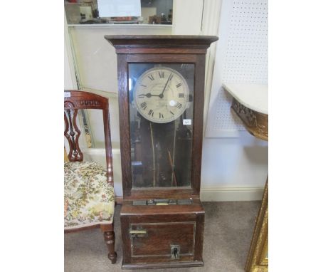 A GLEDHALL BROOK TIME RECORDER the rectangular oak case with circular dial and Roman numerals above a stepped base inscribed 